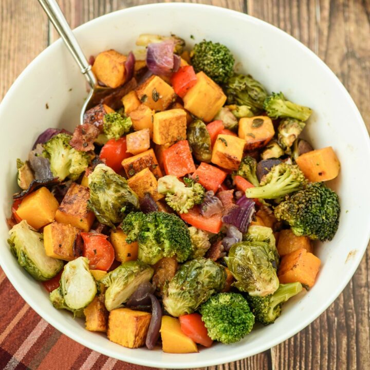 Bowl with roasted vegetables and bacon.