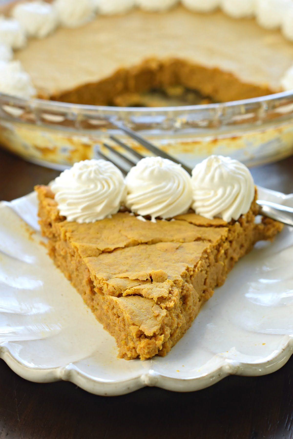 Slice of crustless pumpkin pie with whipped cream.