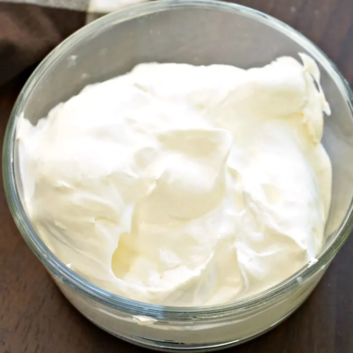 Sugar free whipped cream in a clear glass bowl.