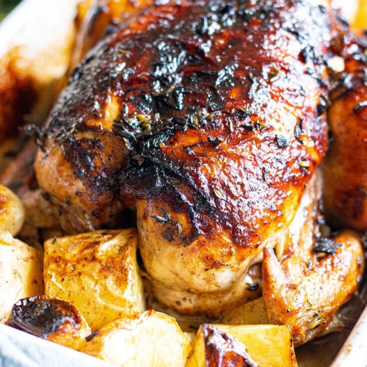 Whole roasted chicken with balsamic glaze and potatoes.