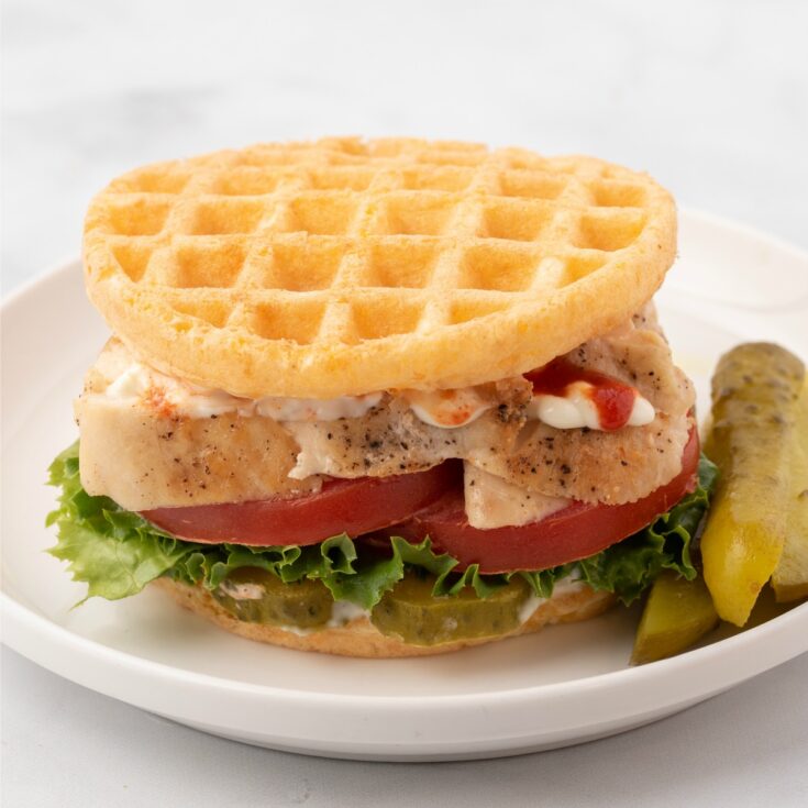 Wondering what to do with those Chaffles? Check out this easy keto dinner idea the whole family will love! A Chicken Cheddar Chaffle Sandwich is full of tender chicken with a zesty flair from dill pickles.