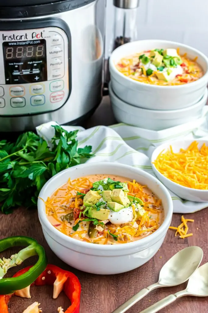 Bowls of chicken fajita soup with Instant Pot in background.
