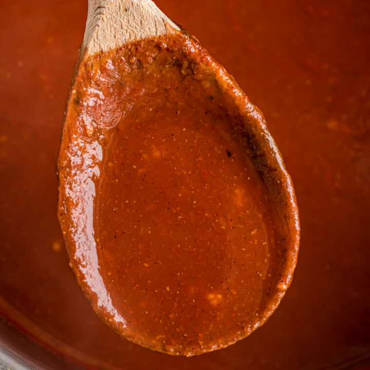 Homemade enchilada sauce on wooden spoon.