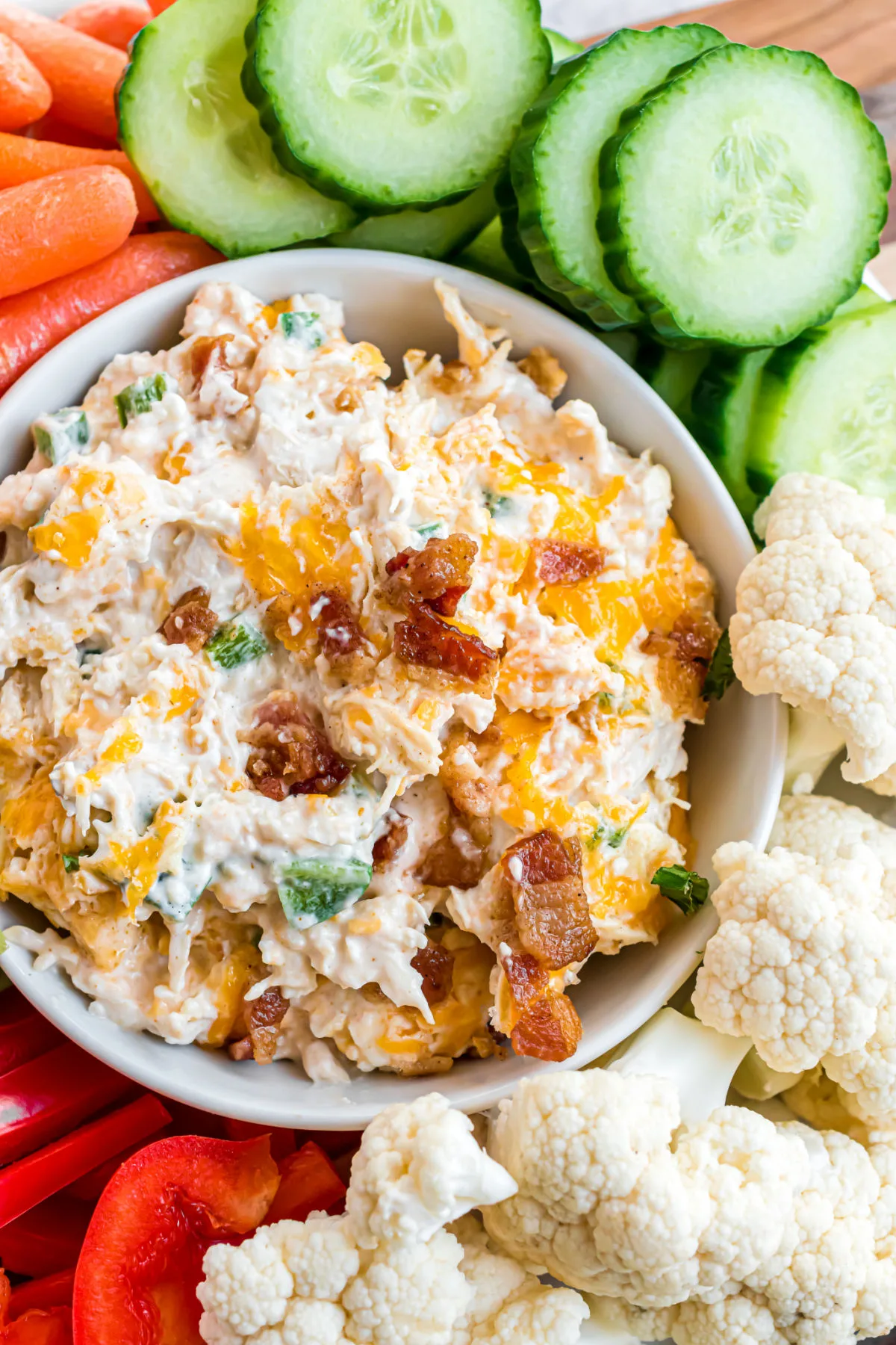Jalapeno popper chicken served as a dip with fresh vegetables.