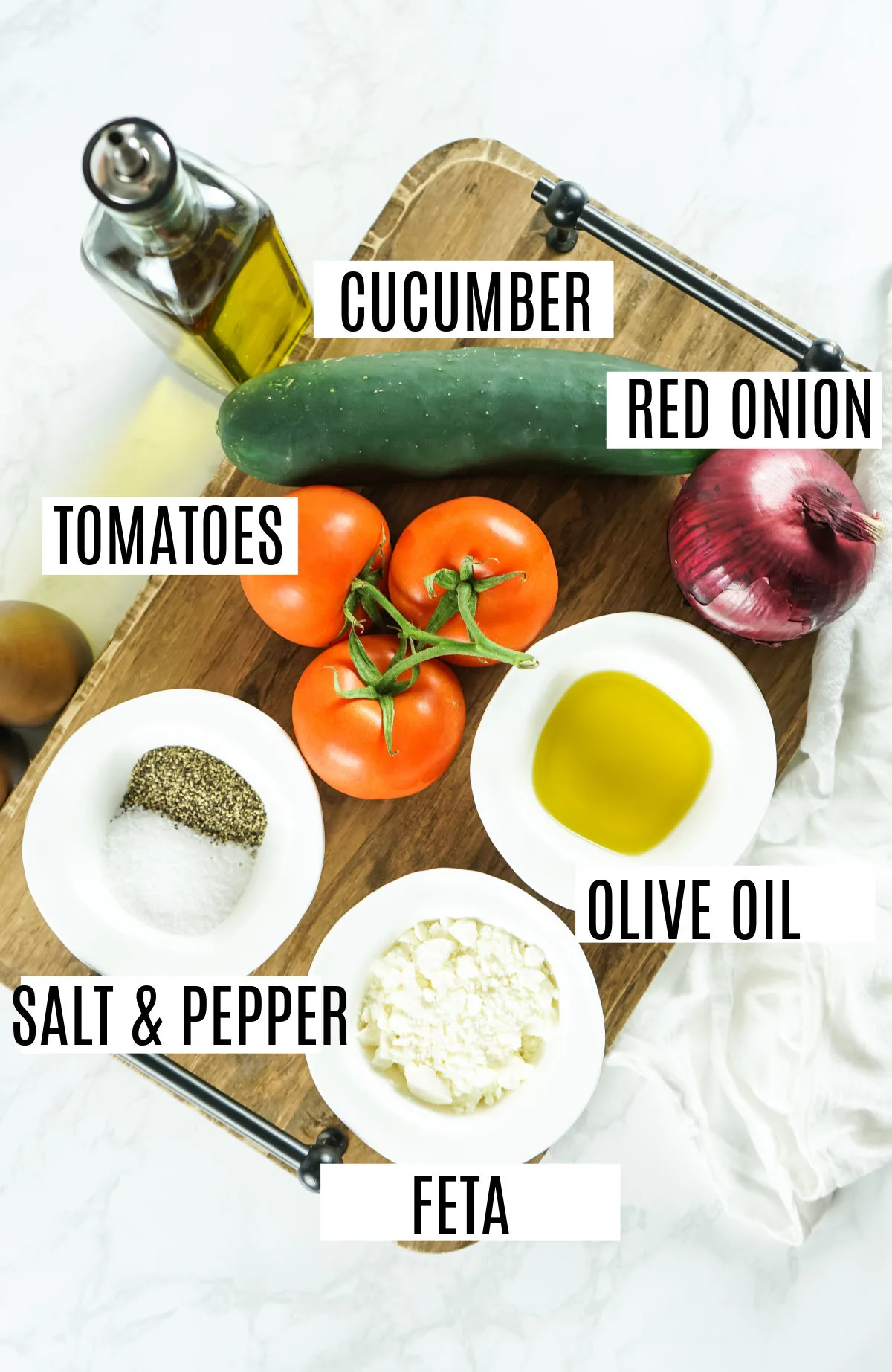 Ingredients needed to make a fresh cucumber tomato salad.