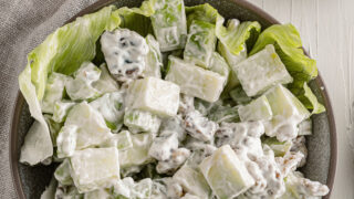 Waldorf salad in a bowl with lettuce.