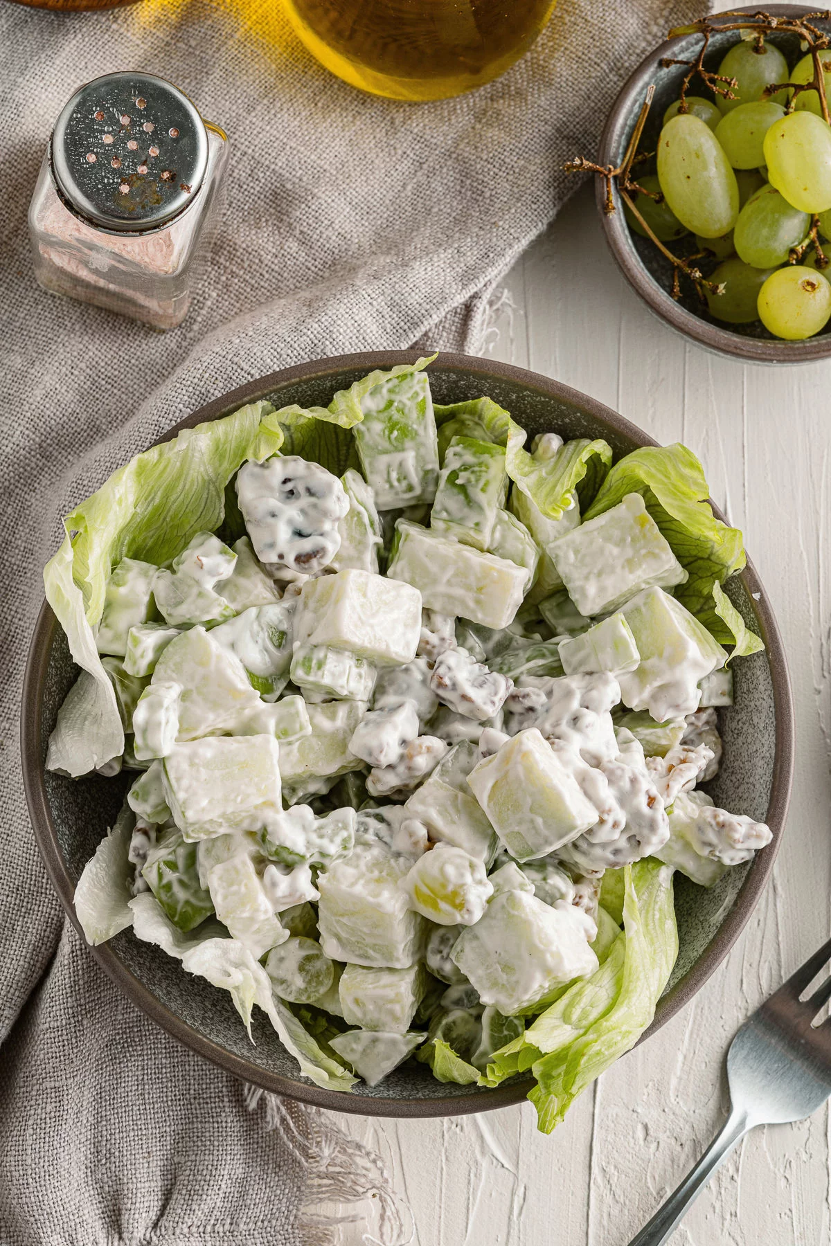 Waldorf salad in a bowl with lettuce.