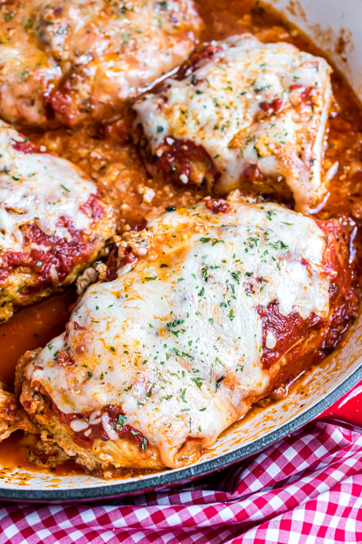 Skillet chicken parmesan topped with marinara and cheese.