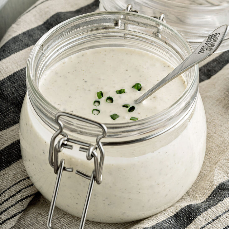 Ranch dressing in mason jar with chives.