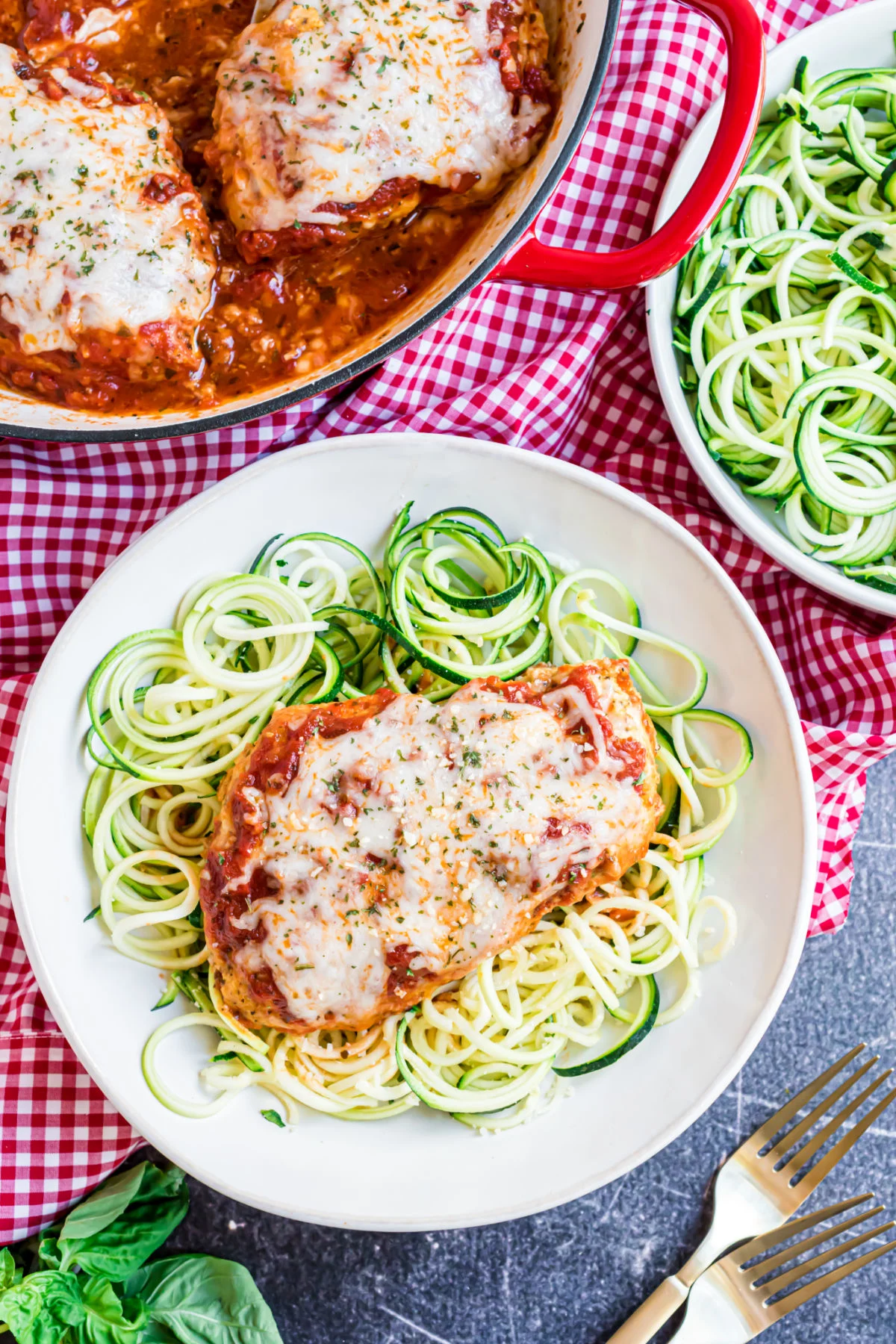 Chicken parmesan served over a plate of zoodles.