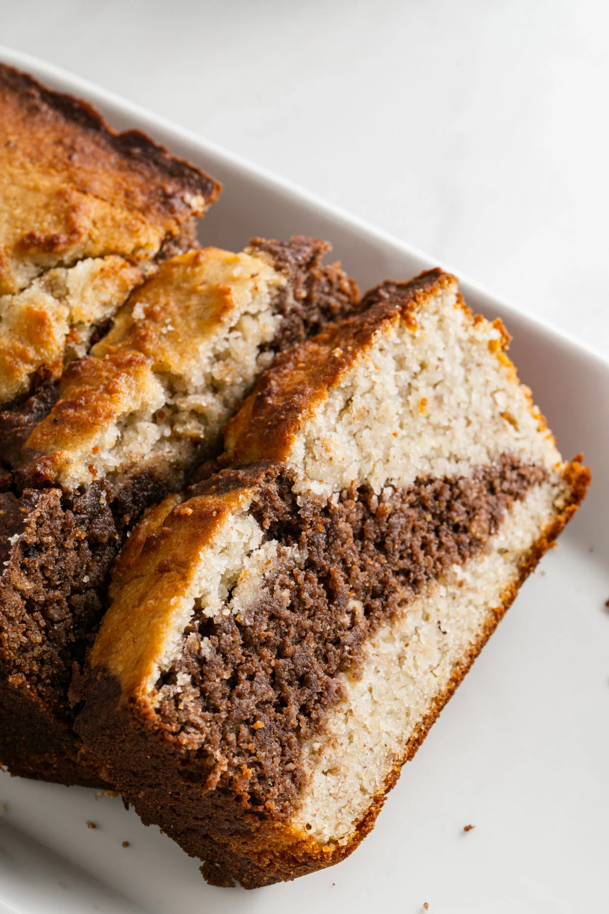 Banana bread slice with a swirl of chocolate in the middle.