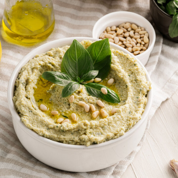 Make your veggie tray more exciting with Pesto Hummus. Chickpeas are blended with basil, pine nuts and garlic to create a flavorful hummus you can serve as a dip or spread.