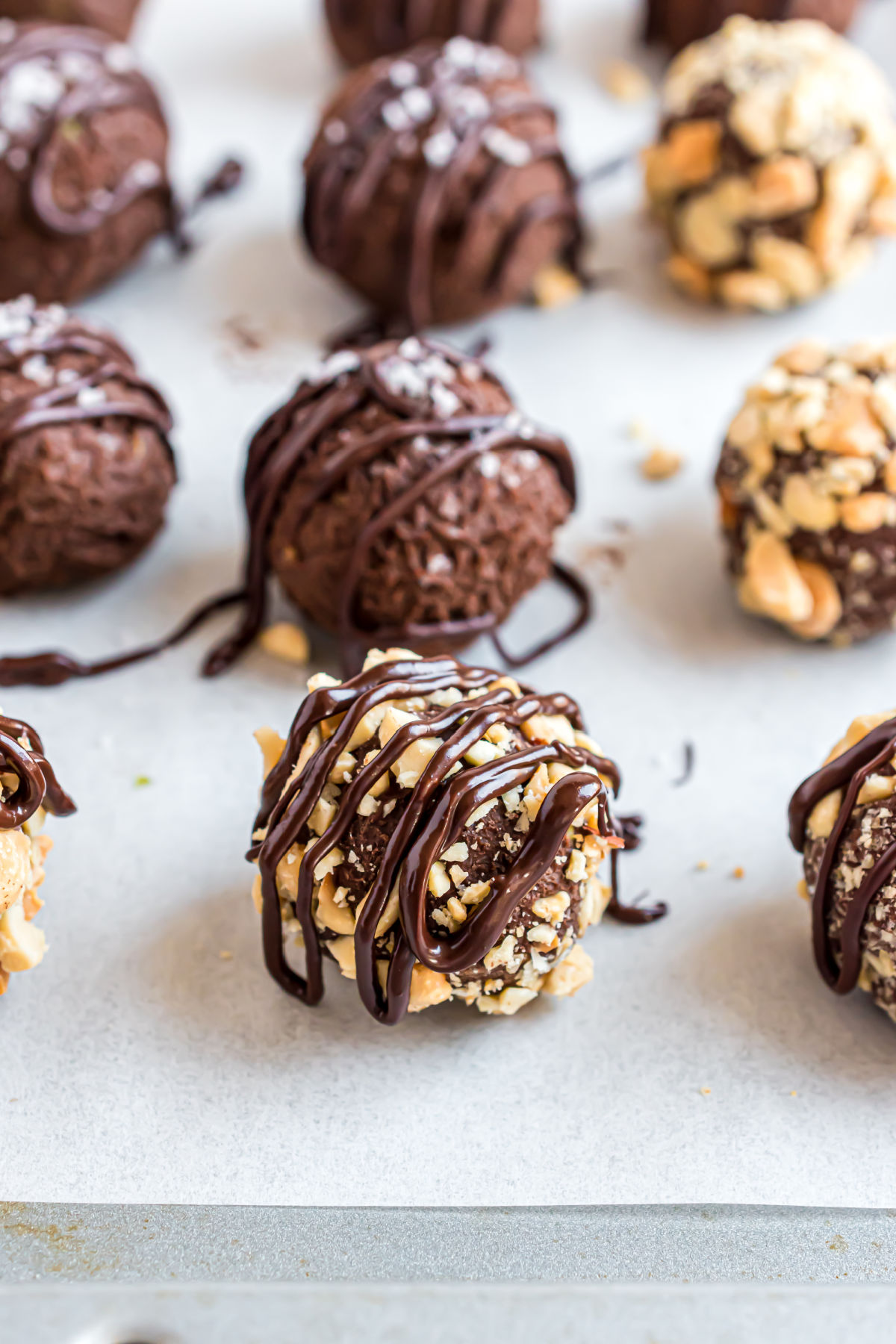 Avocado chocolate truffles on a parchment paper lined cookie sheet.