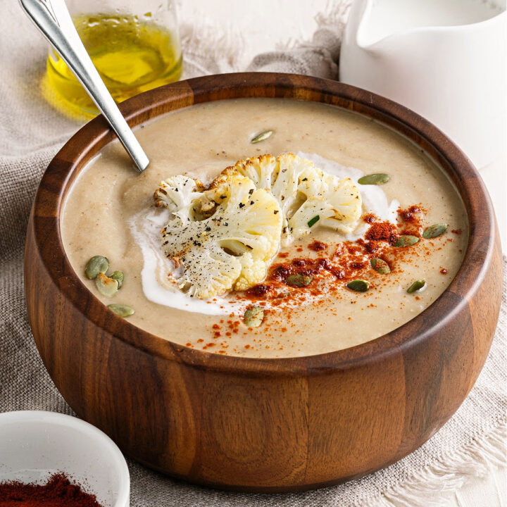 Get cozy with a bowl of hot Cauliflower Soup. Made with roasted cauliflower and garlic, butter and spices, this easy soup recipe needs a place at your dinner table!