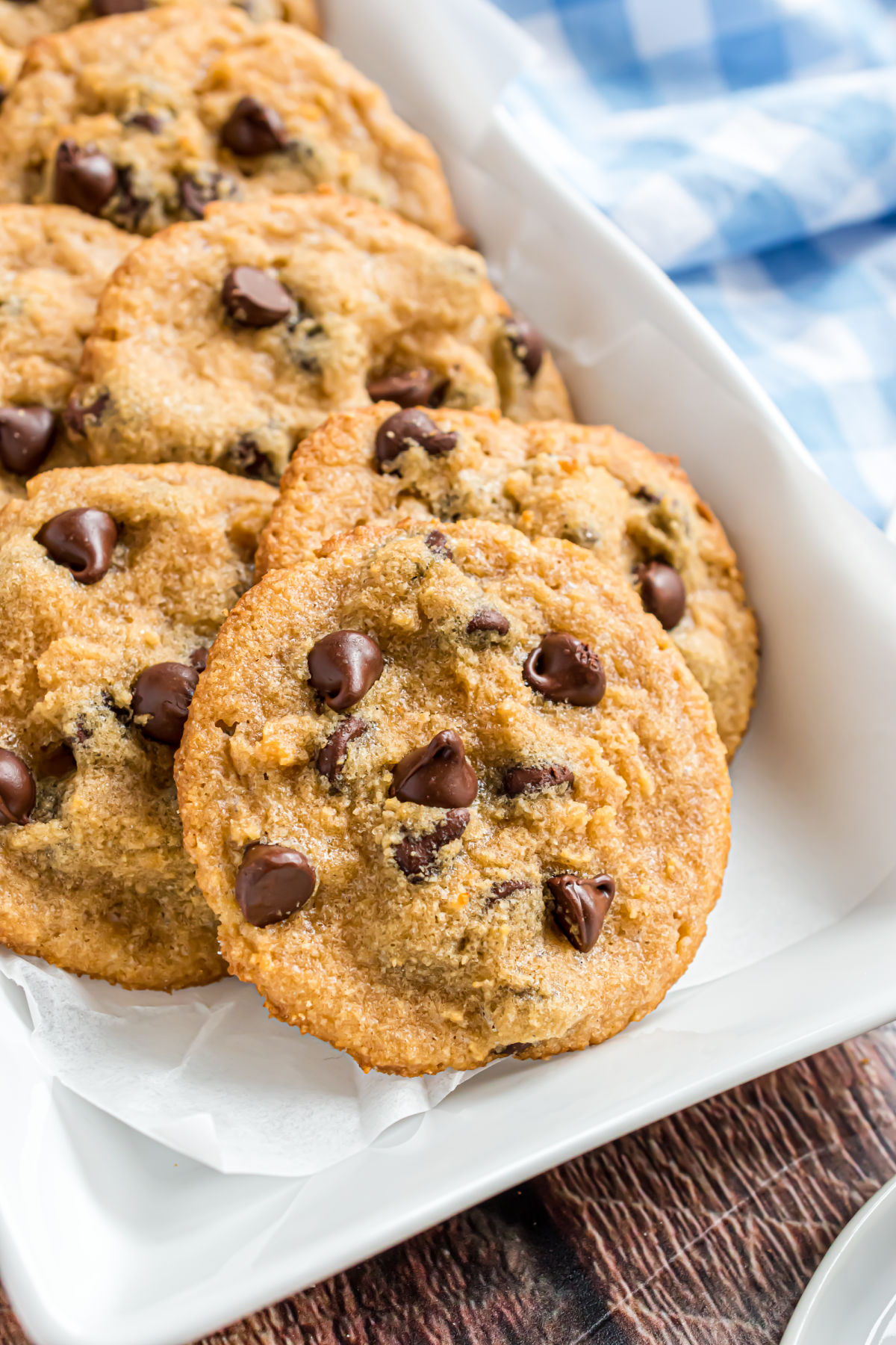 Chocolate chip cookies on white platter for serving.