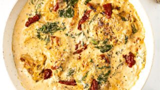 Bring flavors of Italy to your dinner table with this Keto Tuscan Chicken recipe. Pan cooked chicken is covered with a creamy Parmesan sauce and sundried tomatoes for a low carb meal everyone will rave over.