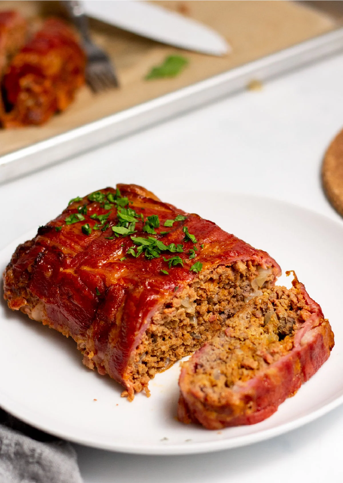 https://nosugarnoflourrecipes.com/wp-content/uploads/2021/11/bacon-wrapped-meatloaf.jpg.webp