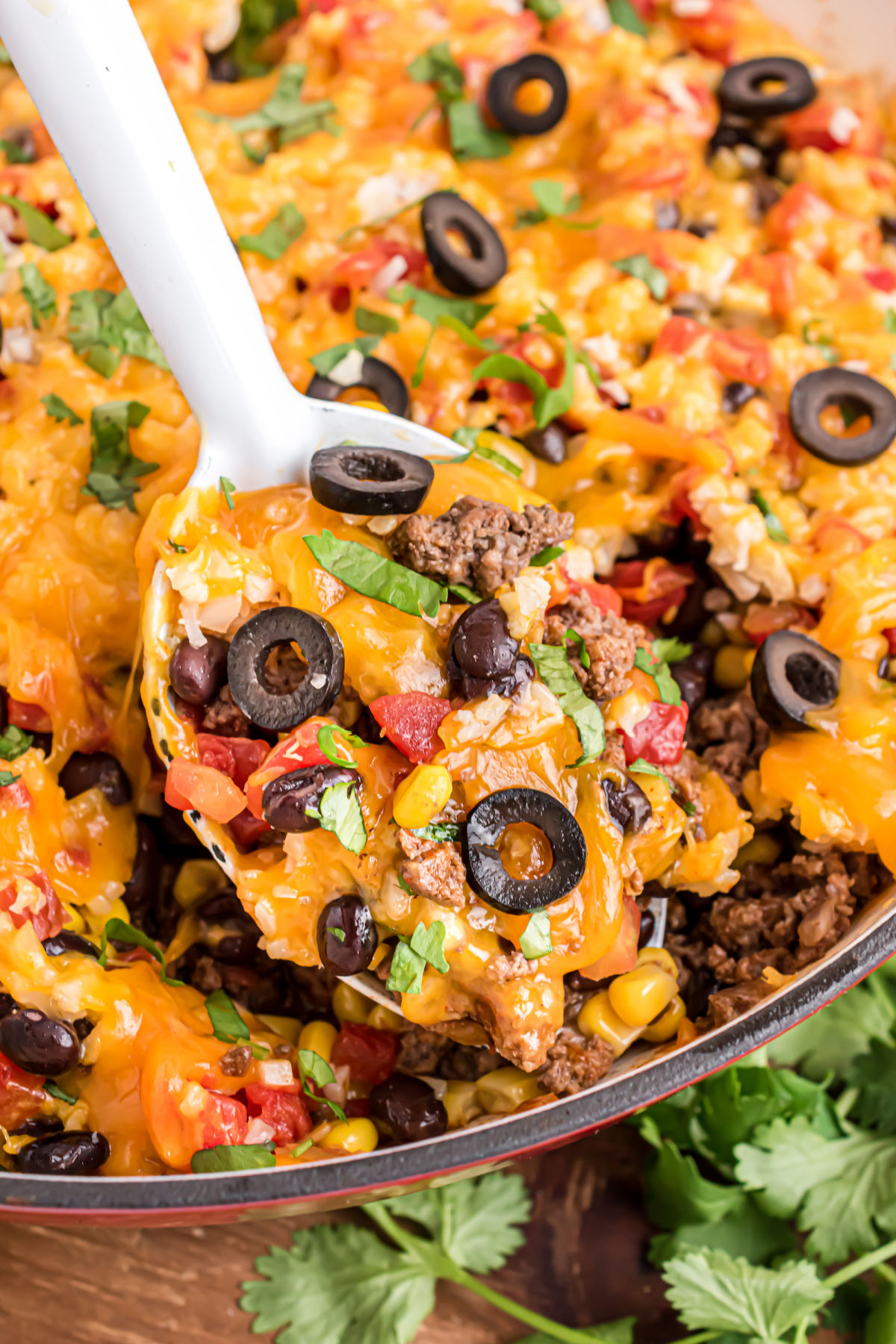 Beef taco casserole served in a large cast iron skillet.