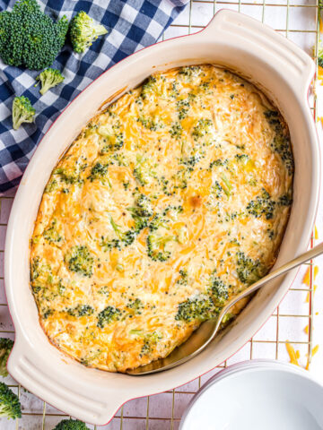Broccoli cheese casserole baked in an oval baking dish.