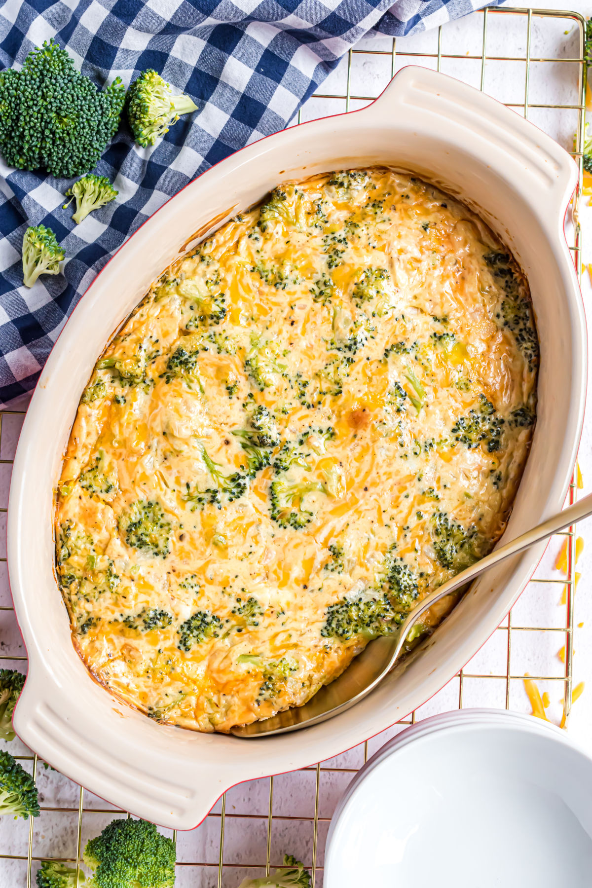 Broccoli cheese casserole baked in an oval baking dish.
