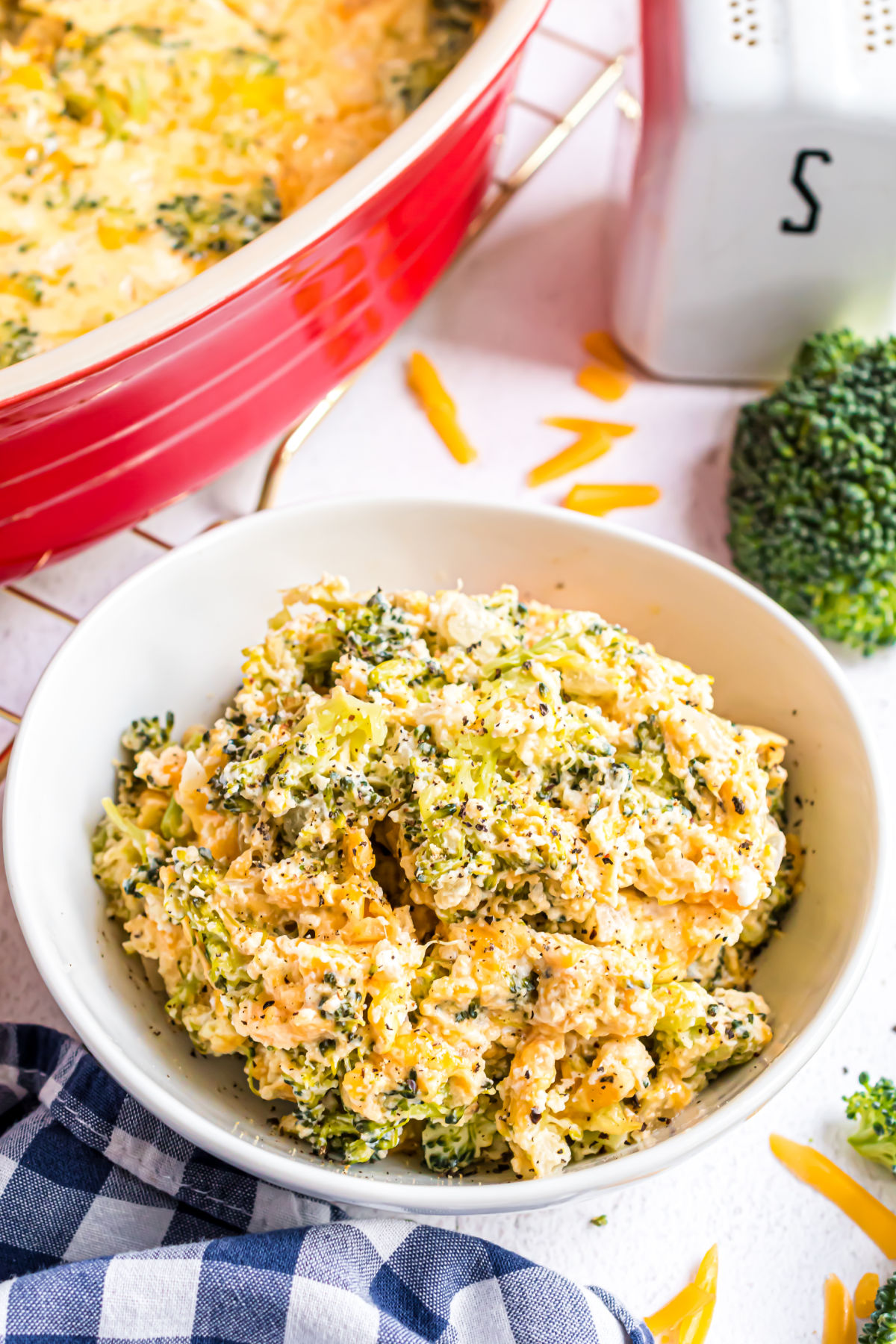 Broccoli cheese casserole scooped into a bowl for serving.