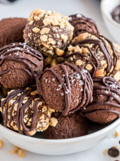 White bowl filled with chocolate truffles.