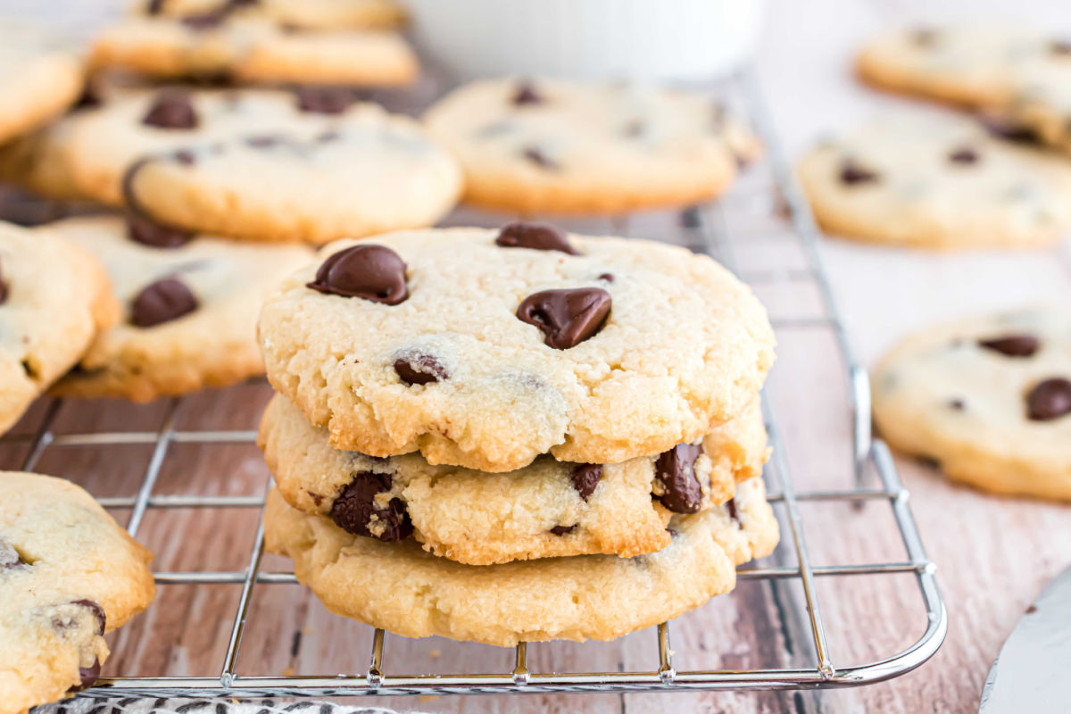 Chocolate chip shortbread cookies stacked on wire rack.