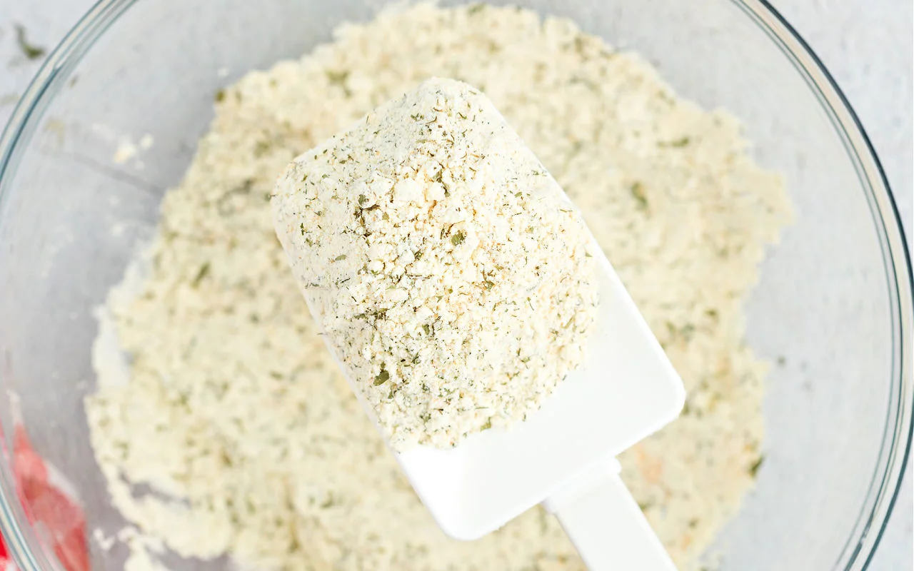 Clear glass bowl with buttermilk dry ranch seasoning.