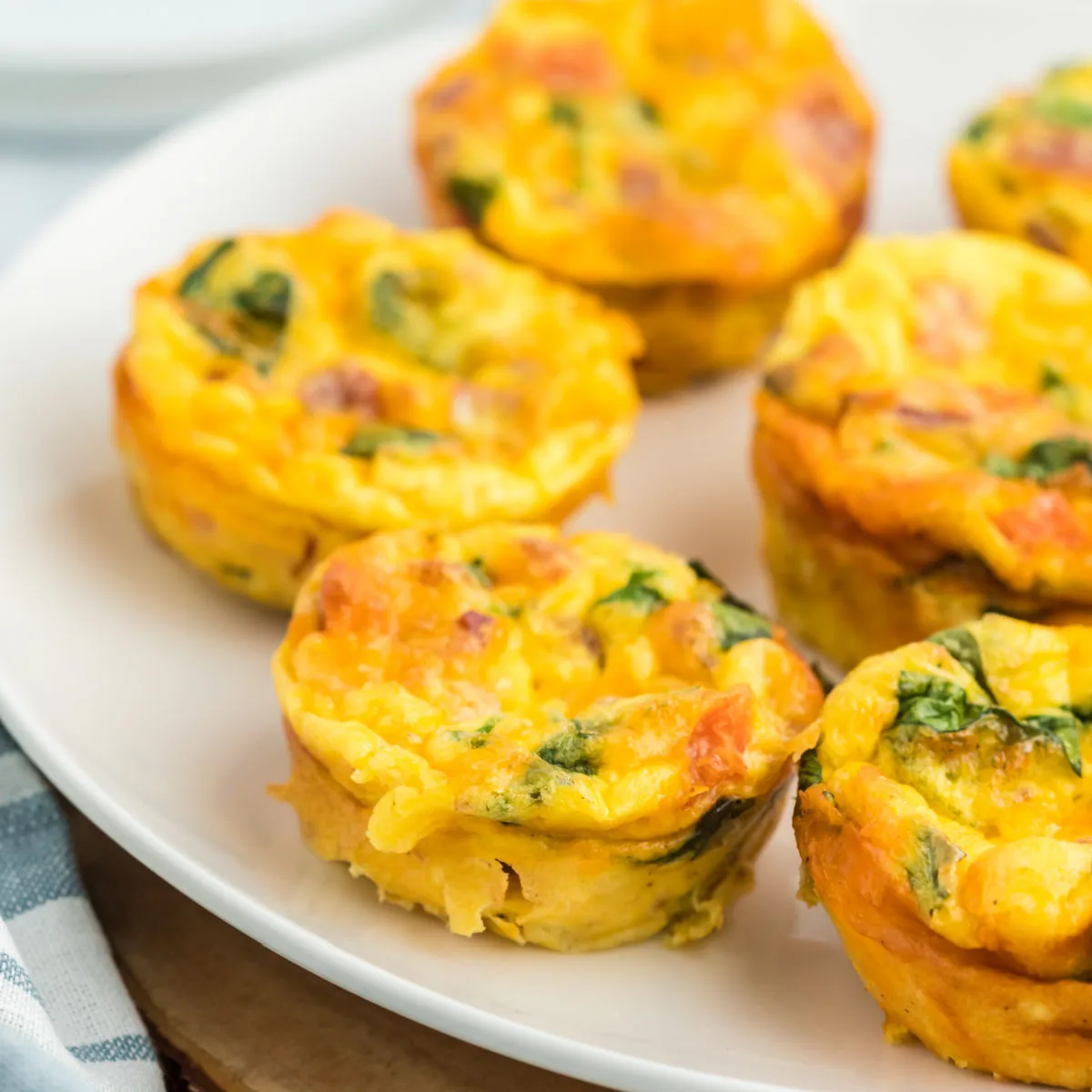 These easy Egg Bites taste like mini frittatas! Made in a muffin tin, they're filled with crispy bacon, fresh spinach and juicy tomatoes for a healthy breakfast or anytime snack.