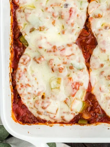 Sausage and Peppers Casserole is an easy meal idea that's low in carbs but full in flavor. This baked casserole has plenty of spicy Italian sausage, baked with peppers and bubbly cheese on top. No bun needed! Slow cooker instructions included!
