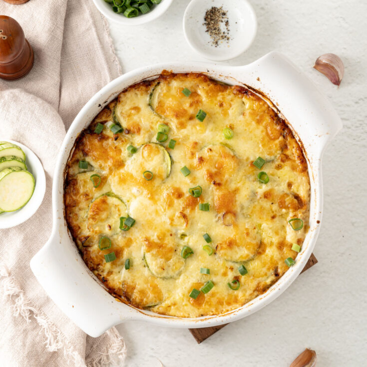 This Baked Zucchini Casserole recipe has layers of zucchini and eggs in a cheesy, garlic cream sauce. High in protein and low in carbs, this casserole is a perfect Keto side dish the whole family will enjoy.