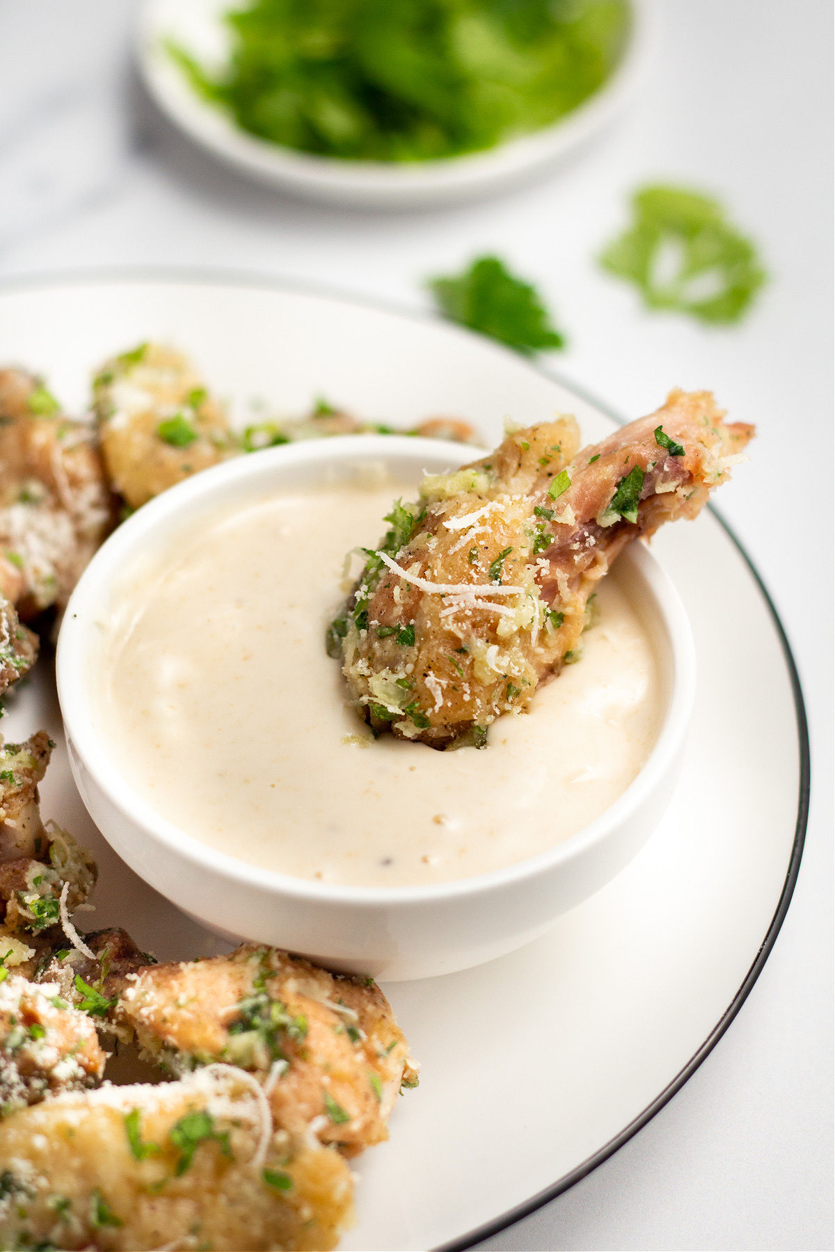 Chicken wing dipped in ranch dressing.