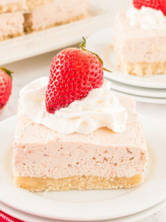 This No Bake Strawberry Cheesecake is an answer to prayer. A creamy cheesecake filling is packed with sweet strawberry flavor on top of a homemade gluten free crust. Made without added sugar, it just might be the perfect cheesecake recipe!