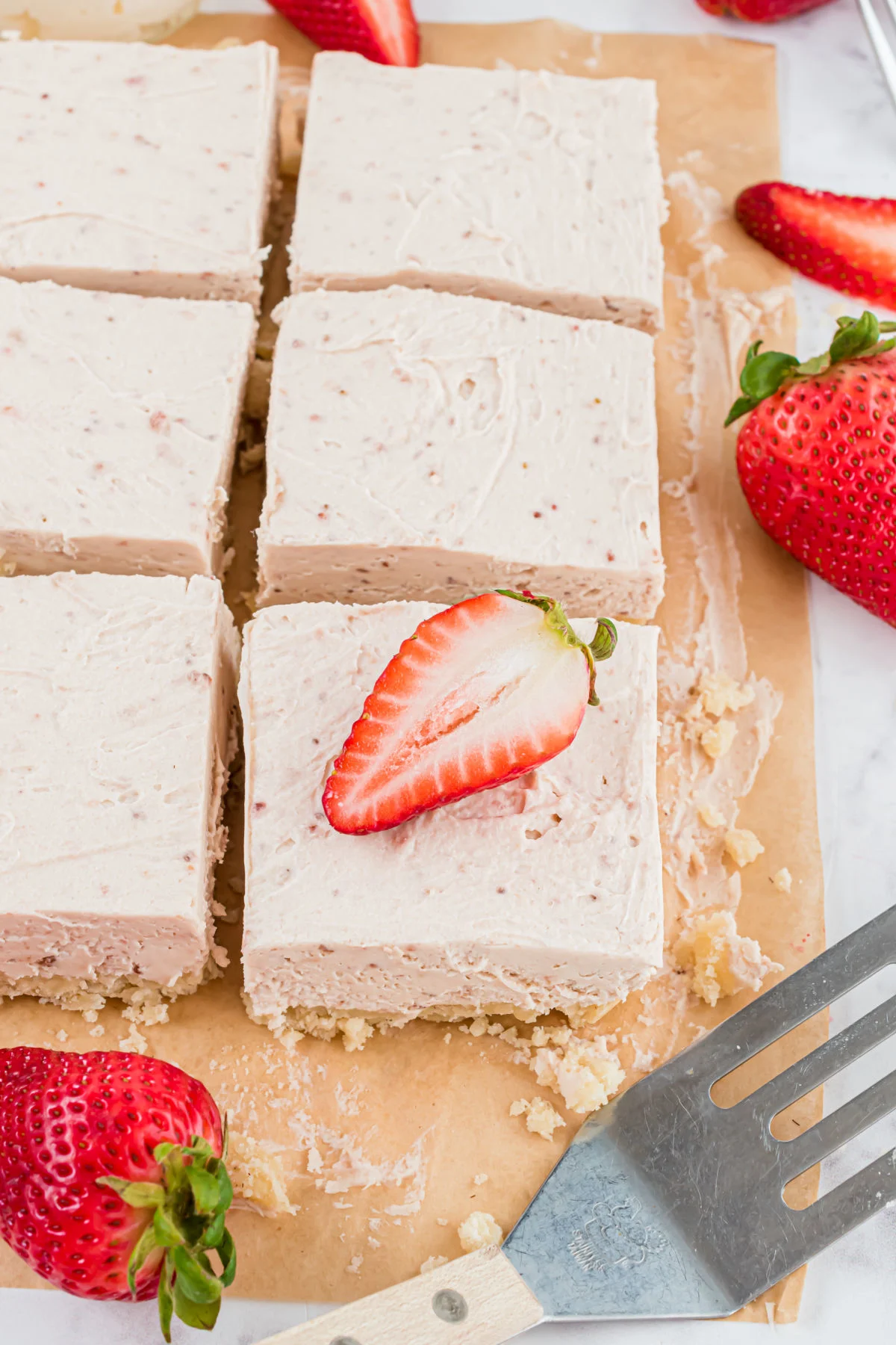 Strawberry cheesecake sliced into squares.
