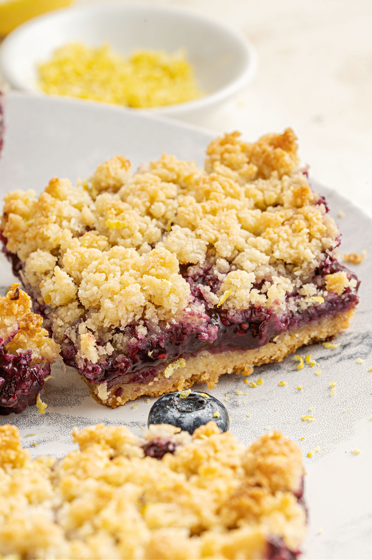 Slice of berry crumble bar.