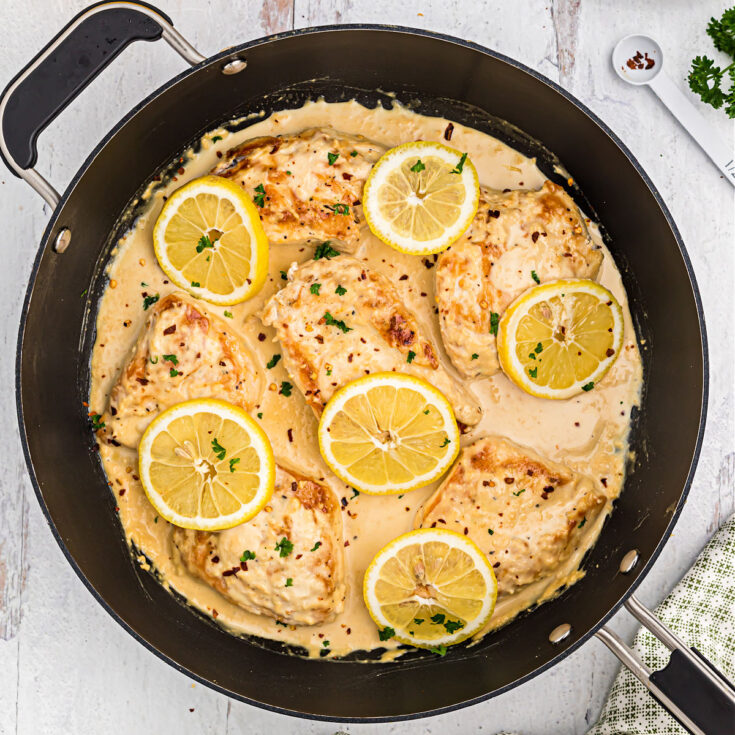 This skillet Lemon Garlic Chicken recipe is a healthy meal idea that's ready in 30 minutes! Your whole family will love the creamy garlic sauce and zesty fresh lemon in this easy keto chicken dinner.