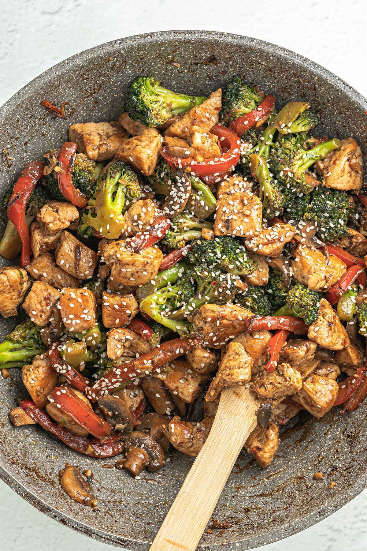 Chicken and vegetable stir fry in a large wok.