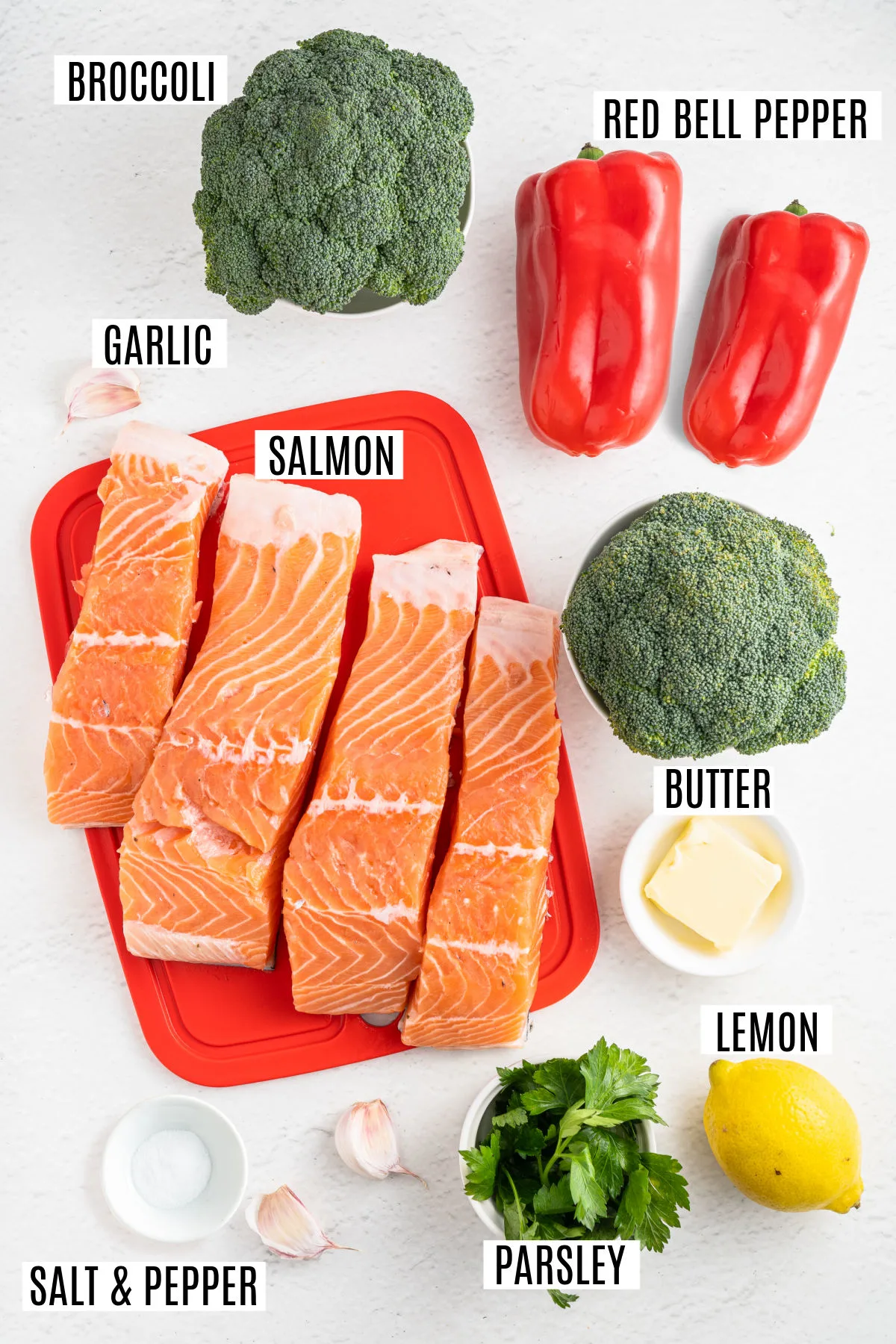 Ingredients needed to make garlic butter salmon on a sheet pan.