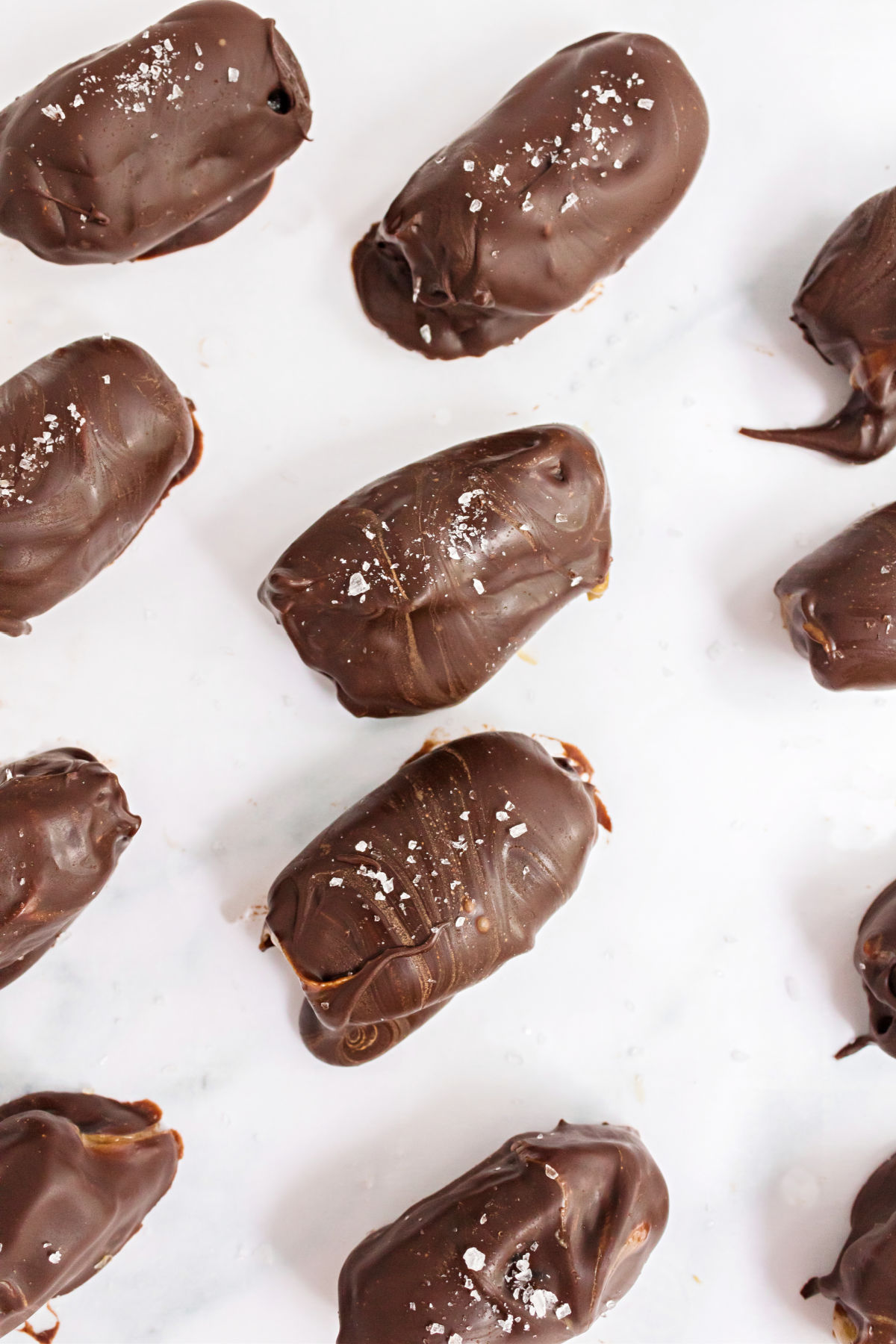 Chocolate covered dates on parchment paper.