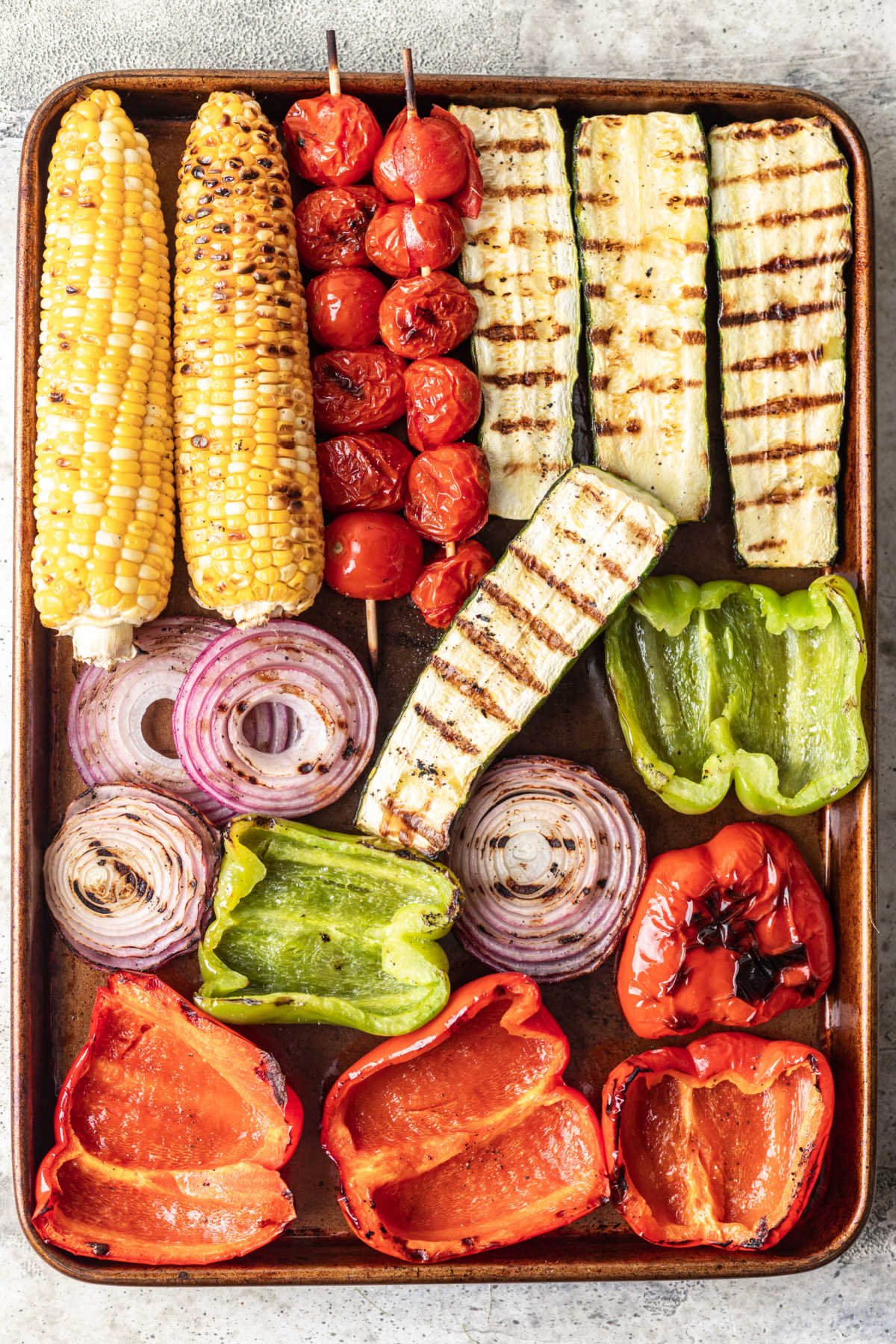 Assorted grilled vegetables served on a cookie sheet.