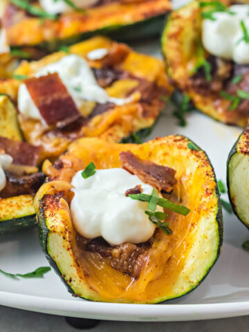 Loaded Zucchini Skins are a great alternative to potato skins—without all the carbs! Perfectly seasoned zucchini are loaded with bacon bits, cheese and sour cream in this quick and easy low carb recipe.