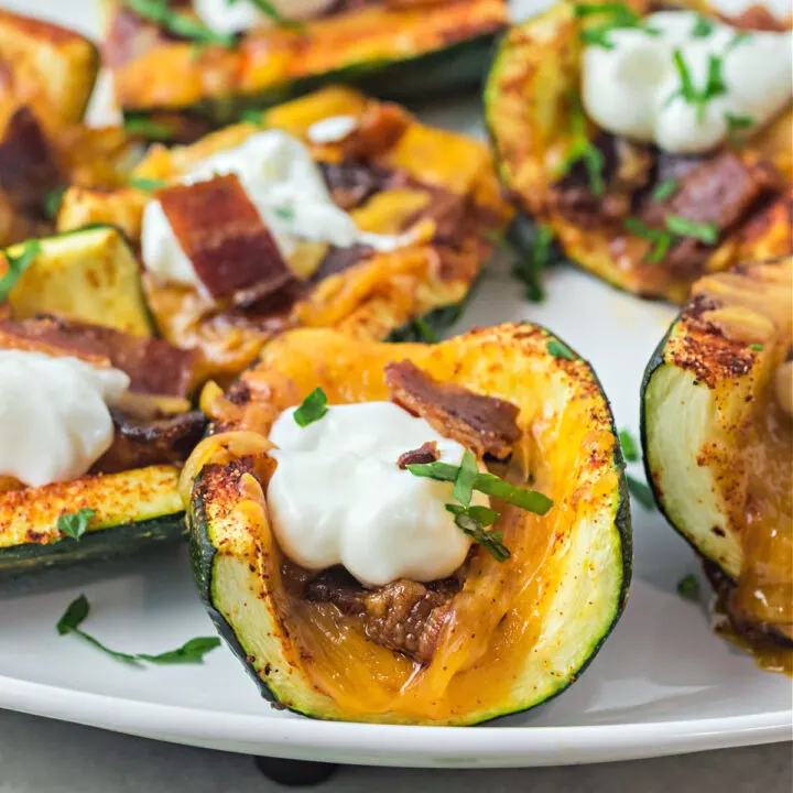 Loaded Zucchini Skins are a great alternative to potato skins—without all the carbs! Perfectly seasoned zucchini are loaded with bacon bits, cheese and sour cream in this quick and easy low carb recipe.